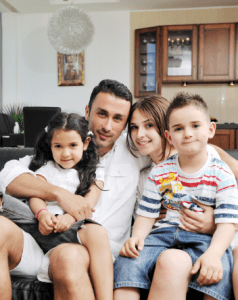 family in a home with two adults and two children.