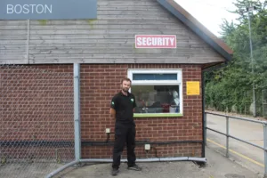 photo of security guard in front of a security office at Metsa Wood